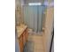 Well-maintained bathroom with a light wood vanity and a blue shower curtain at 1310 Seasons Blvd, Kissimmee, FL 34746