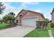Charming single-Gathering home with a two-car garage and a well-manicured front lawn at 1310 Seasons Blvd, Kissimmee, FL 34746