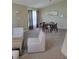 Spacious living room featuring neutral carpet and a dining area at 1310 Seasons Blvd, Kissimmee, FL 34746