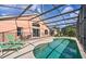 Screened-in private pool with lounge chairs and outdoor seating at 1310 Seasons Blvd, Kissimmee, FL 34746