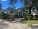 Landscaped front yard with lush greenery, mulch beds, and a decorative flower pot at 1503 N Greenleaf Ct, Winter Springs, FL 32708