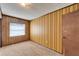 Simple bedroom with patterned wallpaper, carpet, and a window at 23 8Th Ne St, Fort Meade, FL 33841