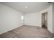 Bedroom with neutral carpet, a window with a view, and a hallway entrance at 409 Ashbury Way, Poinciana, FL 34759