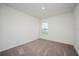 Bedroom features neutral carpet, a window with a view, and fresh paint at 409 Ashbury Way, Poinciana, FL 34759