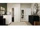 Bedroom with a crib, dark wood dresser and neutral toned walls with three doorways at 5786 Meditation Dr, Clermont, FL 34714