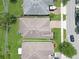 Aerial view of a single-Gathering home with a well-manicured lawn and a brick paved driveway at 9362 Oglethorpe Dr, Groveland, FL 34736