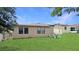 Well-maintained backyard with lush green grass and a patio seating area, perfect for outdoor entertaining at 9362 Oglethorpe Dr, Groveland, FL 34736
