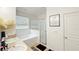 Bright bathroom featuring double sinks, a soaking tub, and a glass-enclosed shower at 9362 Oglethorpe Dr, Groveland, FL 34736