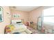 Cozy bedroom with pastel pink walls, vanity, and a comfortable seating area at 9362 Oglethorpe Dr, Groveland, FL 34736
