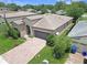 Charming single-story home showcasing a well-manicured lawn and brick driveway at 9362 Oglethorpe Dr, Groveland, FL 34736