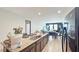 Open-concept kitchen with granite countertops and a view to the living area at 9362 Oglethorpe Dr, Groveland, FL 34736
