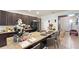 Spacious kitchen island with granite countertops and bar seating, alongside modern appliances at 9362 Oglethorpe Dr, Groveland, FL 34736