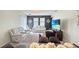 Comfortable living room with a large TV, modern sofas and a view to the dining area at 9362 Oglethorpe Dr, Groveland, FL 34736