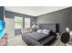 Stylish primary bedroom featuring a tufted headboard and ample natural light at 9362 Oglethorpe Dr, Groveland, FL 34736