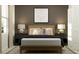 Serene bedroom featuring a modern bed frame, stylish nightstands, lamps, and a baseball diamond art piece at 4156 Singing Mockingbird Blvd, Bartow, FL 33830