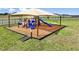 Community playground with slides, climbing structures, and sunshade, providing a safe and fun environment for children at 4156 Singing Mockingbird Blvd, Bartow, FL 33830