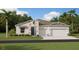 Beautiful single-story home with a two-car garage and stone accents, set on a lush green lawn at 5680 Vinyasa Rd, Clermont, FL 34714