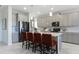 Modern kitchen featuring gray cabinetry, a center island with seating, and stainless steel appliances at 5680 Vinyasa Rd, Clermont, FL 34714