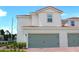 Charming two-story home featuring a two-car garage, red tile roof, neutral siding and a well-manicured front yard at 628 Bay Leaf Dr, Poinciana, FL 34759