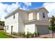 A charming two-story home featuring neutral siding and a well-manicured front yard under a bright blue sky at 628 Bay Leaf Dr, Poinciana, FL 34759