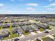 An aerial view of a community of single Gathering homes with blue skies at 653 Vittorio Dr, Winter Haven, FL 33884