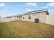 A view of the backyard of a home with some grass and a fence at 653 Vittorio Dr, Winter Haven, FL 33884