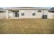 View of the backyard of a home, featuring a covered porch at 653 Vittorio Dr, Winter Haven, FL 33884