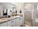 Bathroom featuring double sink vanity with granite counters and glass shower enclosure at 653 Vittorio Dr, Winter Haven, FL 33884