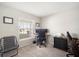 Office area with a modern computer setup, a large window offering natural light, and neutral-toned carpet at 653 Vittorio Dr, Winter Haven, FL 33884