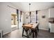 Cozy dining area with modern chandelier, and sliding glass doors leading to the backyard at 653 Vittorio Dr, Winter Haven, FL 33884