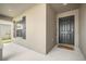 A welcoming front entryway with an elegant dark front door, a 'hello' door mat, and decorative window shutters at 653 Vittorio Dr, Winter Haven, FL 33884