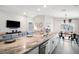 Modern kitchen island with counter seating, stainless steel sink, and an open layout to the living area at 653 Vittorio Dr, Winter Haven, FL 33884