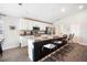 Open kitchen design with stainless steel appliances, white cabinetry, and a large island with barstools at 653 Vittorio Dr, Winter Haven, FL 33884