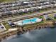 Aerial view of the community pool in a well-maintained neighborhood, complete with palm trees and ample space at 653 Vittorio Dr, Winter Haven, FL 33884