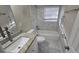 Modern bathroom featuring tiled shower and floors, vanity with granite countertop, and updated fixtures at 1804 S Mellonville Ave, Sanford, FL 32771