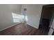 Bedroom with wood-look flooring, closet, and bright sunlight from window at 1804 S Mellonville Ave, Sanford, FL 32771