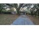 Charming single-story home with a large yard and mature trees covered in Spanish moss at 1804 S Mellonville Ave, Sanford, FL 32771