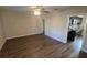 Open living room featuring a ceiling fan and wood-look floors, seamlessly connecting to the kitchen at 1804 S Mellonville Ave, Sanford, FL 32771