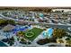 Aerial view of a well-planned community with RV parking, playground, lake, and lush landscaping at 2024 Count Ct, Lakeland, FL 33813