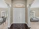 Entryway showcasing marble floors, white pillars and an arched doorway leading to the living area at 2024 Count Ct, Lakeland, FL 33813