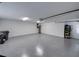 Spacious garage with epoxy flooring, water heater, and ample room for storage and vehicles at 2024 Count Ct, Lakeland, FL 33813