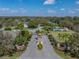 Gated community entrance featuring manicured landscaping, guard house, and mature trees at 2024 Count Ct, Lakeland, FL 33813