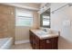 Bathroom featuring a large vanity with a sink and neutral ceramic tiles in the shower and floor at 819 22Nd Nw St, Winter Haven, FL 33881