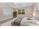 Bright bedroom featuring plush carpet, a ceiling fan, and views of the outdoors at 819 22Nd Nw St, Winter Haven, FL 33881
