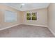 Empty bedroom boasting neutral walls, a ceiling fan, two windows and carpet flooring at 819 22Nd Nw St, Winter Haven, FL 33881