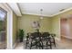 Dining area features a modern table set, stylish rug, and view of backyard at 819 22Nd Nw St, Winter Haven, FL 33881