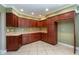 Spacious kitchen showcasing tile floors, recessed lighting, and ample wood cabinet storage at 819 22Nd Nw St, Winter Haven, FL 33881