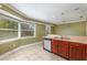 Kitchen features tile flooring, a bay window, stainless steel dishwasher and wood cabinets at 819 22Nd Nw St, Winter Haven, FL 33881