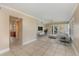 Bright living room featuring tile flooring, a ceiling fan, and access to the outdoors at 819 22Nd Nw St, Winter Haven, FL 33881