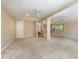 Spacious living area boasts neutral walls, carpet flooring, ceiling fans, and staircase at 819 22Nd Nw St, Winter Haven, FL 33881